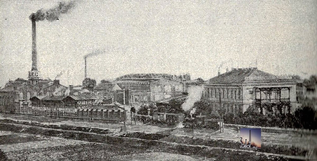 Die Fabrik der A.E.G.-Union Elektrizitätsgesellschaft. Links der noch heute existente Schornstein mit Maschinen- und Kesselhaus. Fotografie, 1910. Quelle: Paul, Martin: Technischer Führer durch Wien, Wien 1910, S. 582